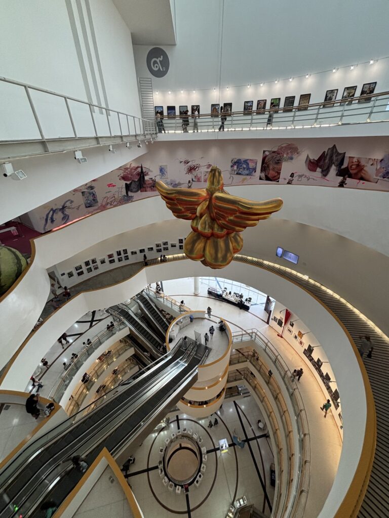 Spiral atrium of the Bangkok Art and Culture Centre with golden bird sculpture