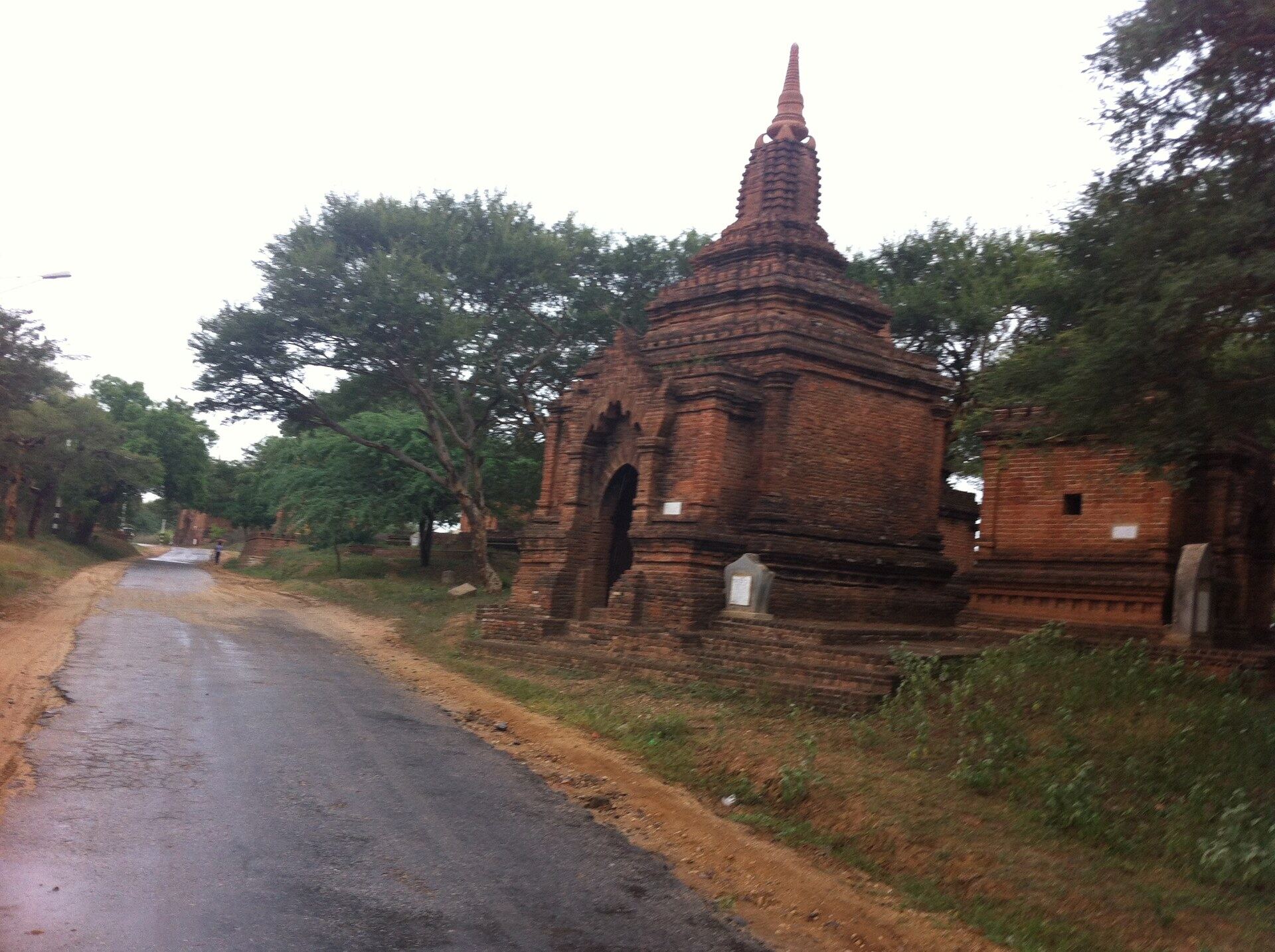 Brick pagoda beside a quiet road Bagan Myanmar