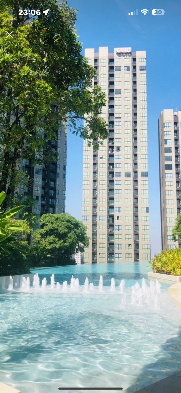 Bangkok high-rise residential towers seen from a pool deck