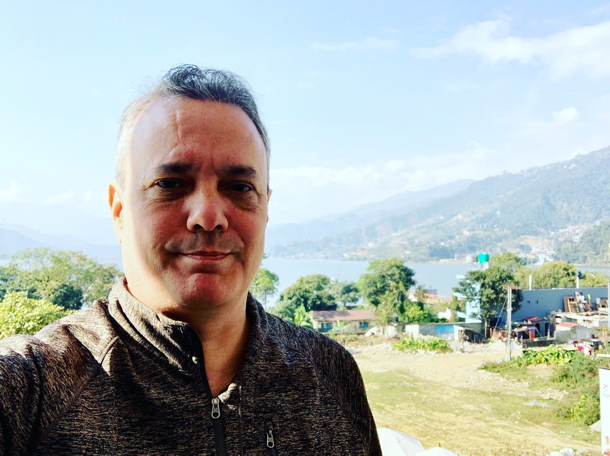 Sebastien at Phewa Lake, Pokhara, Nepal, with the Annapurna mountains in the background